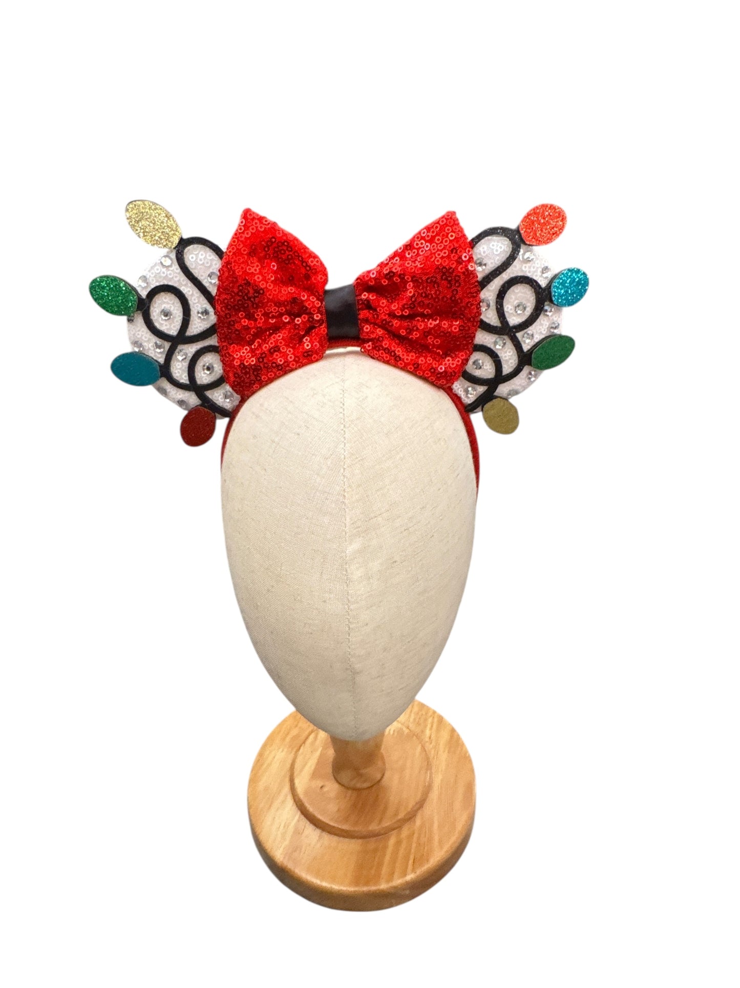 Red bow headband on a mannequin head with a white background