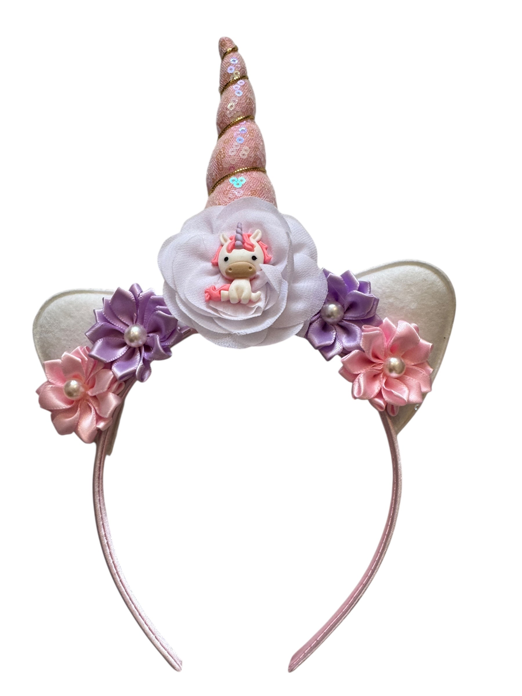 Unicorn-themed headband with floral decorations on a white background