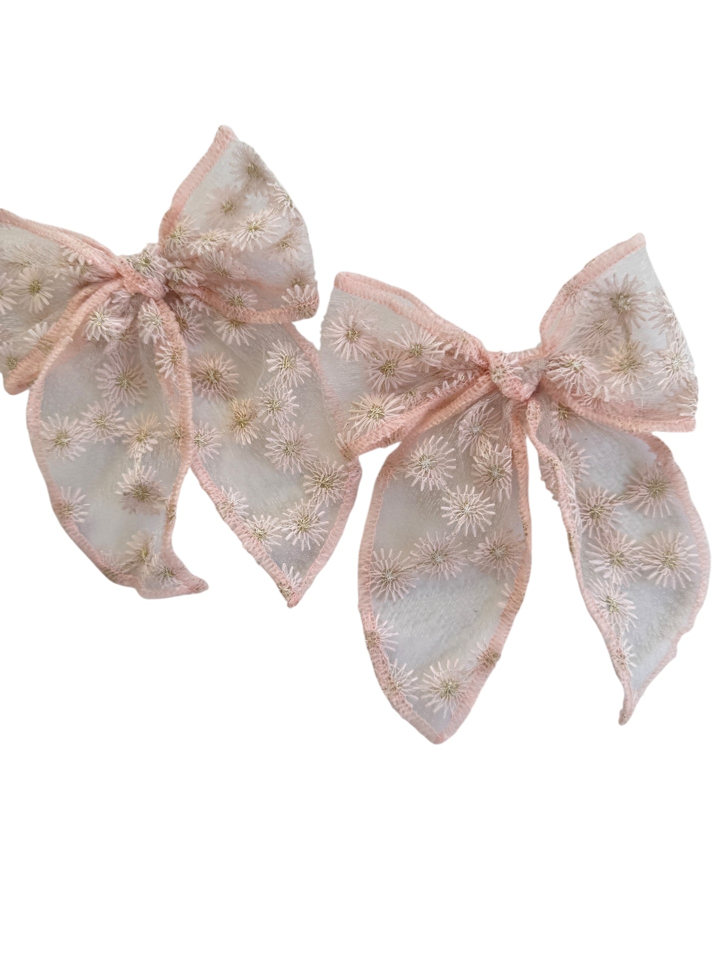 Two decorative bows with floral patterns on a white background