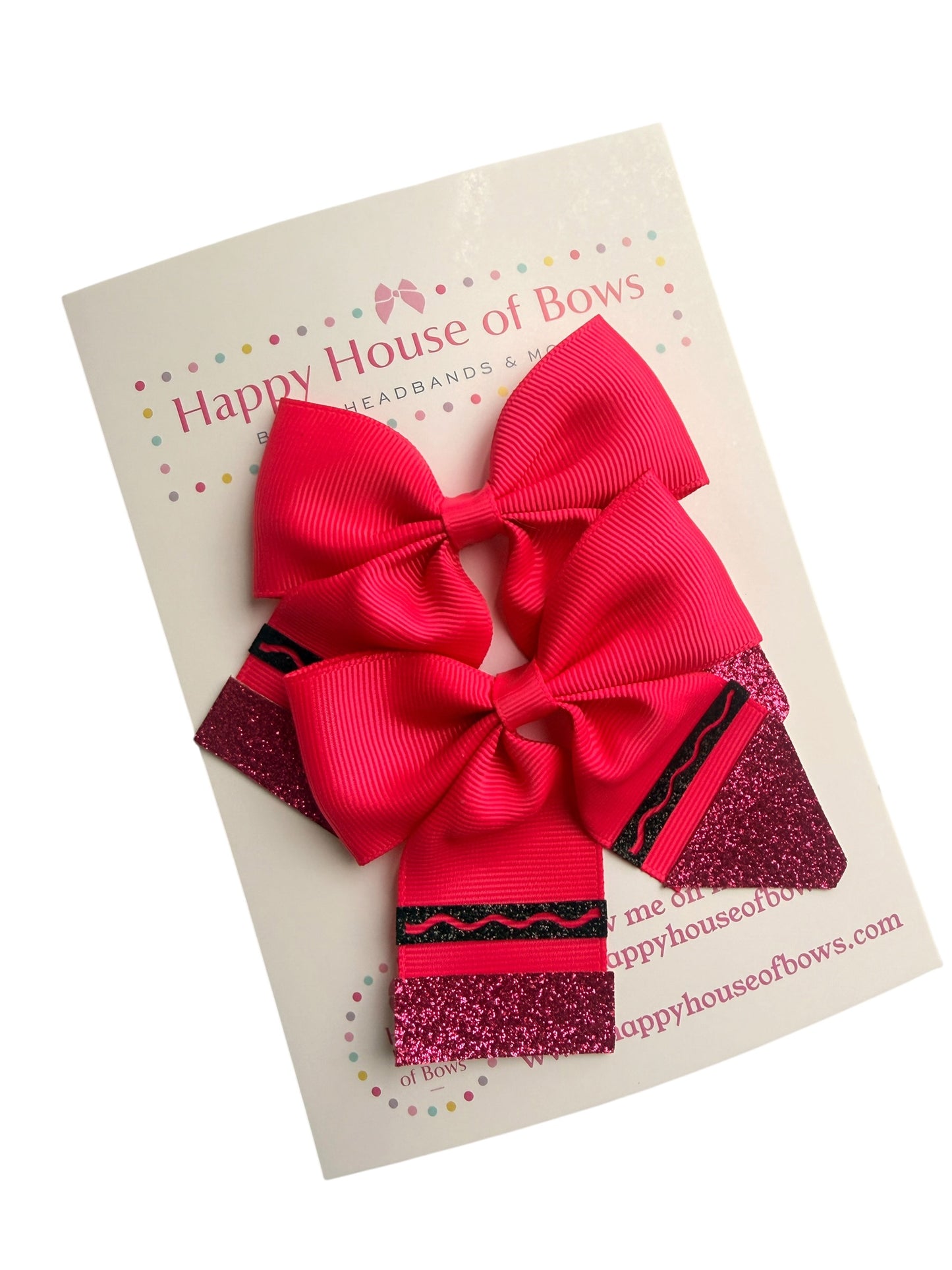 A set of three hair bows from Happy House of Bows, featuring a large bright pink ribbed grosgrain bow on top of two smaller matching bows with glittery magenta and black patterned ends, presented on a branded white backing card.