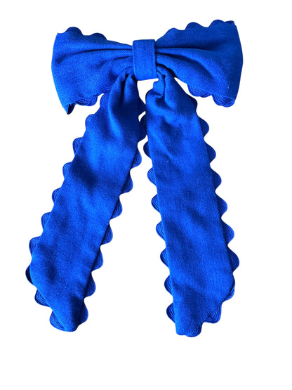 Blue hair bow with ruffled edges on a white background