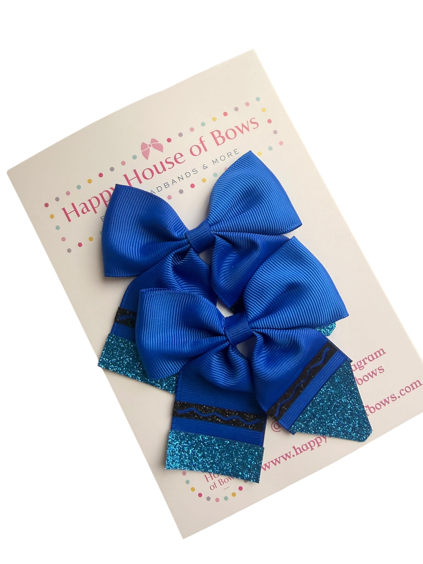 A set of three royal blue hair bows, including two large ribbed grosgrain bows and one smaller glitter bow, displayed on a cream-colored card from Happy House of Bows.