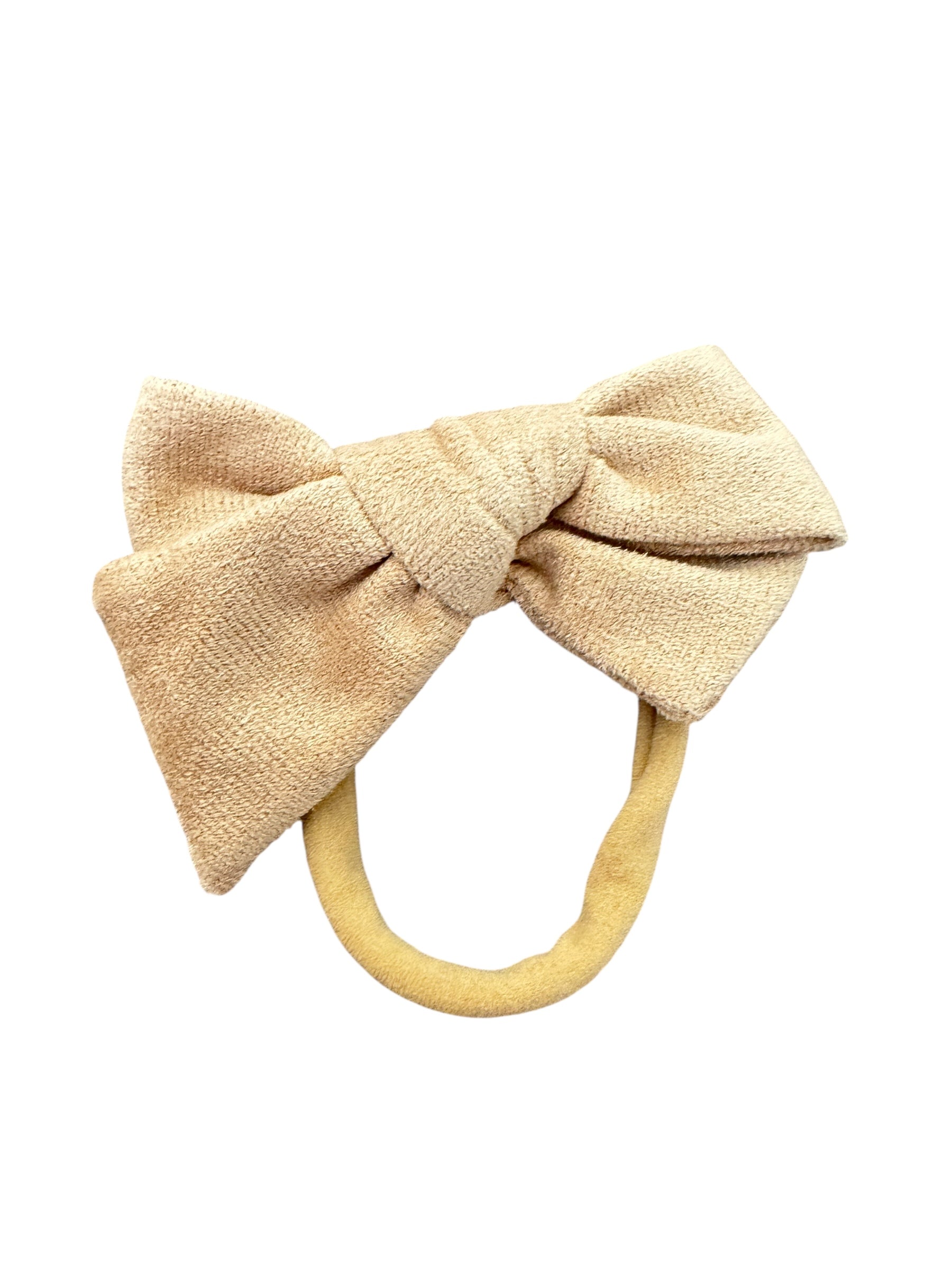 Beige bow-shaped hair tie on a white background