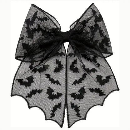 Bow with black bat patterns on a sheer background