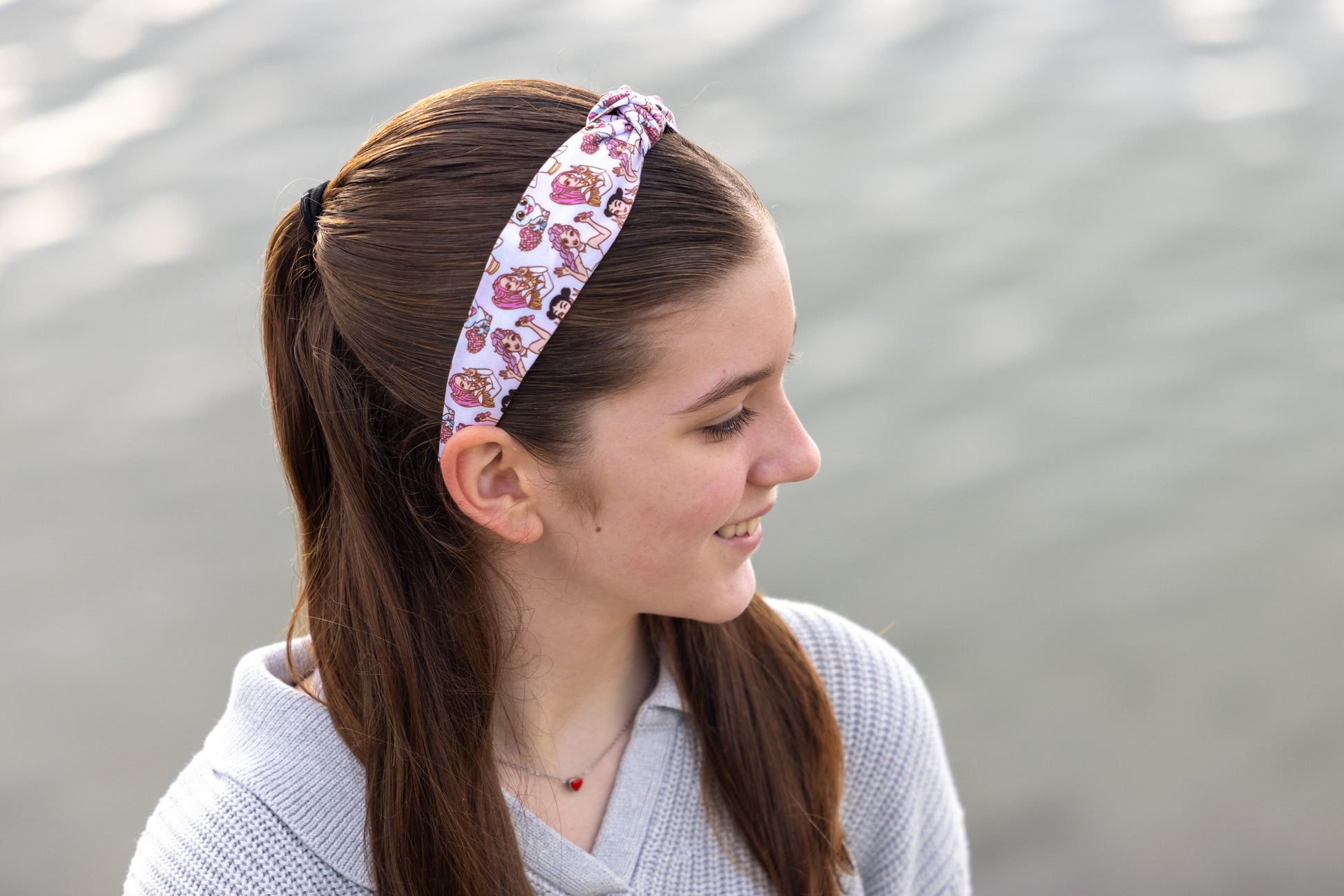 Woman wearing a floral headband with a blurred background