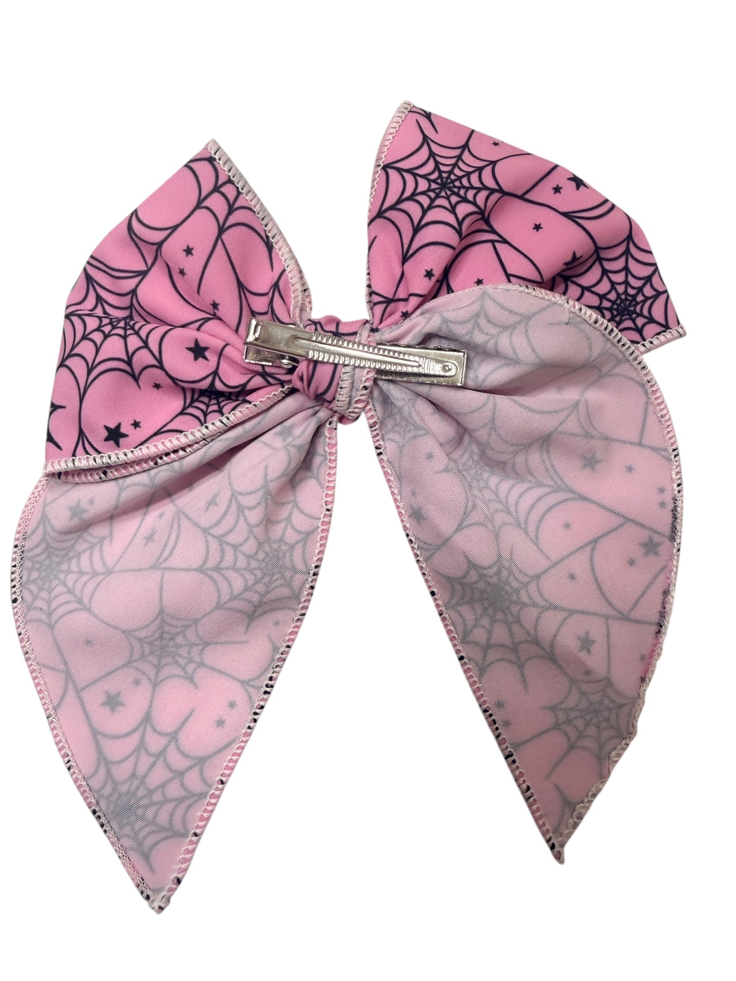 A pink hair bow featuring a secured with a silver metal clip.
