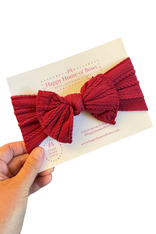 Red knotted headband held over a card with 'Happy House of Bows' branding.