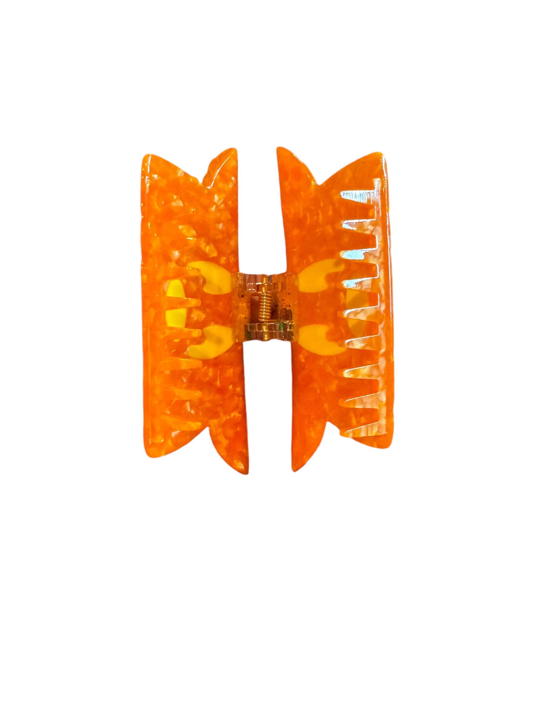 An orange pumpkin-shaped Halloween mouse ear claw clip against a white background