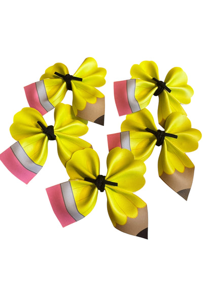 Yellow pencil hair clips on a white background