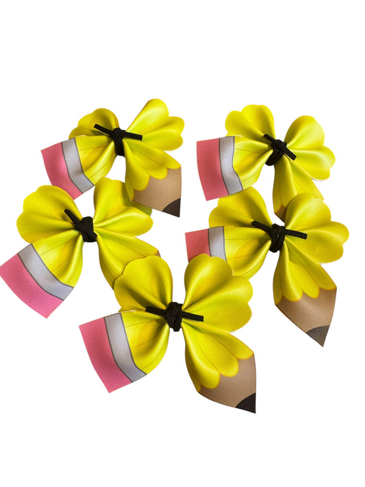 Yellow pencil hair clips on a white background