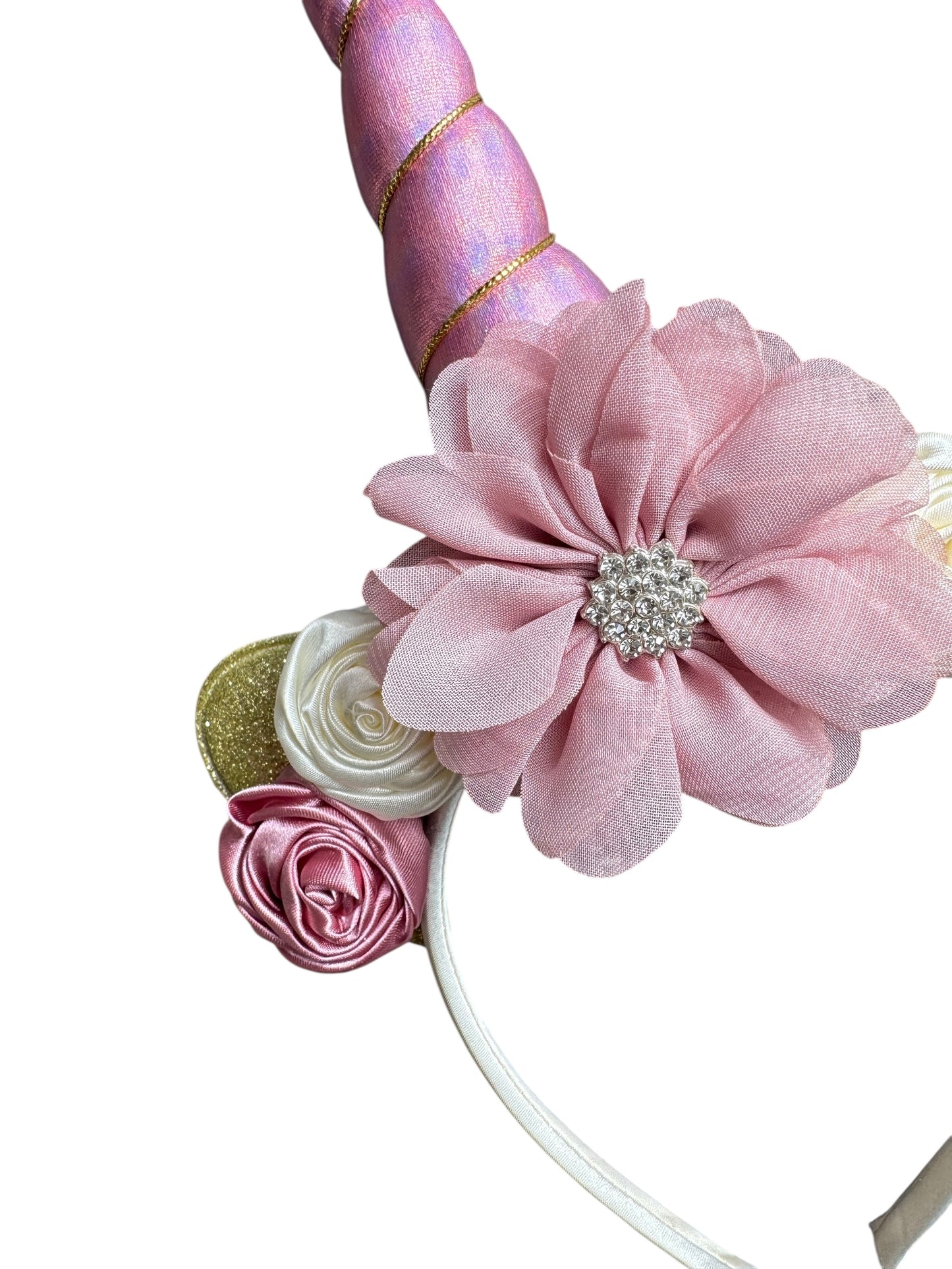 Unicorn horn headband with pink flowers and decorative elements on a white background