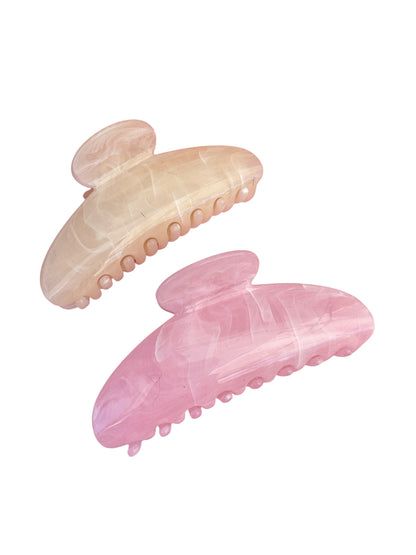 Two pink hair clips on a white background