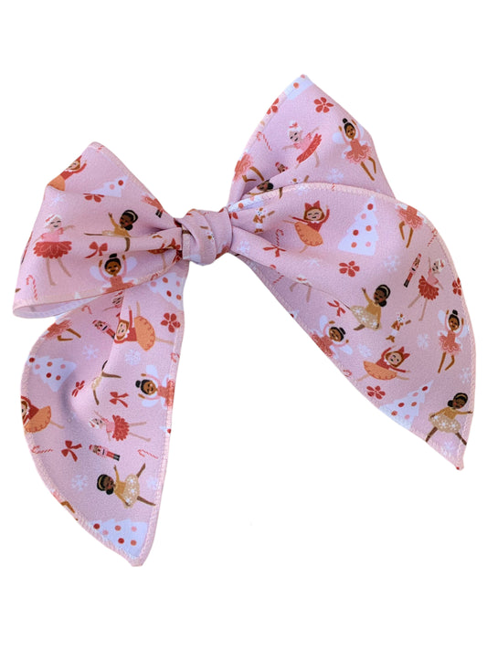 A collection of pink nutcracker hair bows with different patterns, displayed on a white background.