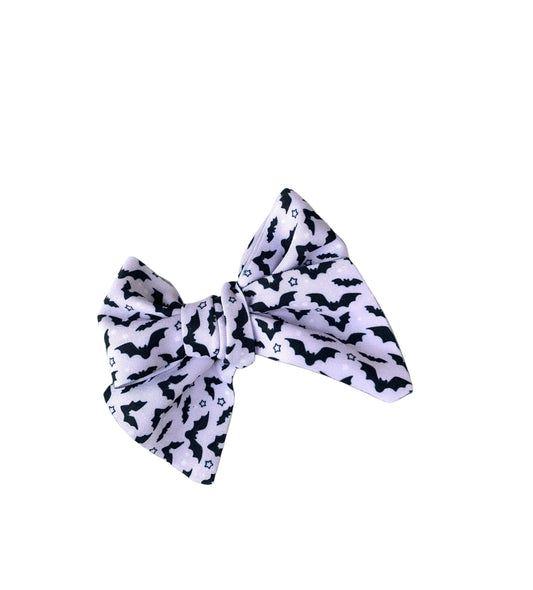 Small Lavender bat hair bow on a white background.