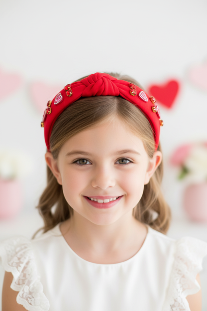 Girl wearing rhinestone hearts headband