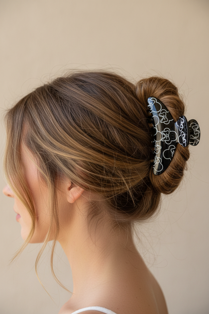 Woman wearing Black Minnie Claw Clip in messy bun
